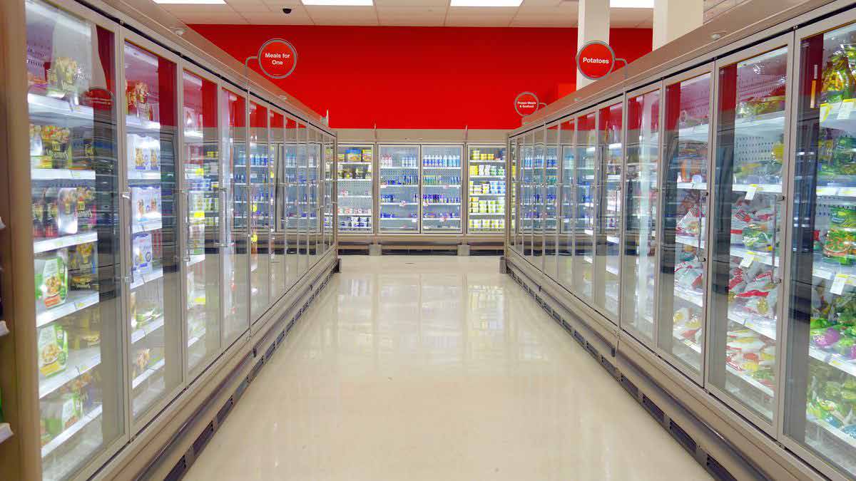 Interior of a Baraar supermarket showing well-stocked upright freezer aisles